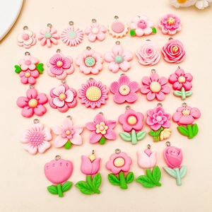Assortment of pink resin flower pendants including roses and daisies for DIY jewelry