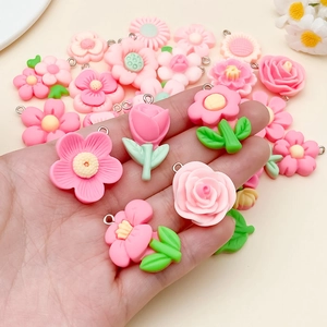 Detailed view of mixed pink resin flower charms for DIY jewelry making and necklaces