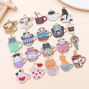 Macro detail of cute enamel cat and coffee cup charms for DIY jewelry making