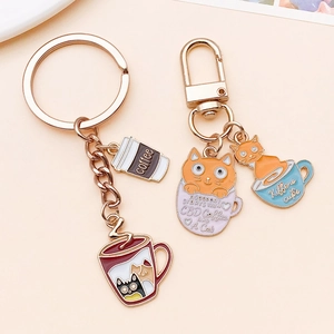 Detail of cat and coffee enamel pendants with rose gold plating for DIY keychains