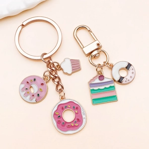 Detail of rose gold enamel donut and cupcake charms on premium metal keychains