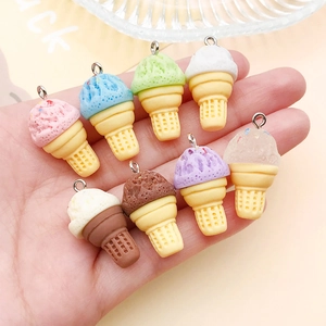 Macro shot of 8 colorful resin ice cream cone pendants with metal rings held in hand