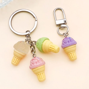 Detail of four macaron-colored faux ice cream cone keychains with metal silver hooks