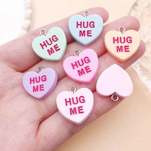 Colorful resin heart pendants with Hug Me text for DIY jewelry making and keychains