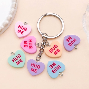 Mix of colorful resin heart charms with Hug Me text for DIY keychains and jewelry making