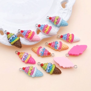 Detail of colorful resin strawberry ice cream cone pendants with metal rings and waffle texture