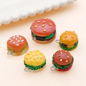 Detailed close-up of resin mini burger charms with realistic sesame and lettuce layers