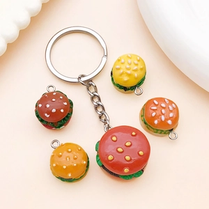 Detailed view of five mini resin burger charms for DIY keychains and jewelry making