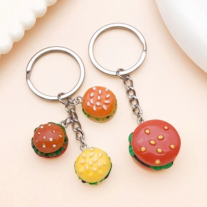 Close-up of mini resin hamburger keychains with realistic layered food details and rings