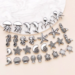 Detail of antique silver sea life charms including starfish, sea turtles and seahorses