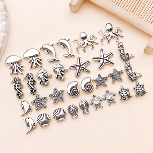 Flat lay of antique silver sea creature alloy beads for DIY jewelry making