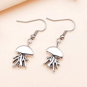 Macro shot of silver jellyfish dangle earrings with smooth tentacles and polished finish
