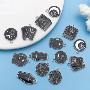Gothic style black enamel pendants with mystical charms like spells book and crystal ball