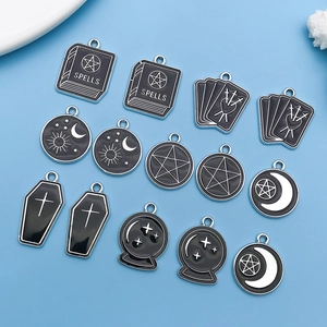 Macro view of gothic black enamel charms with moon and star patterns for DIY jewelry