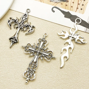 Detailed close-up of antique silver gothic cross pendants with intricate engravings
