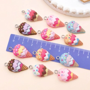 Macro shot of colorful resin ice cream charms with metal loops for DIY jewelry making