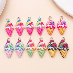 Flat lay of resin ice cream cone pendants with bows for DIY jewelry making kits
