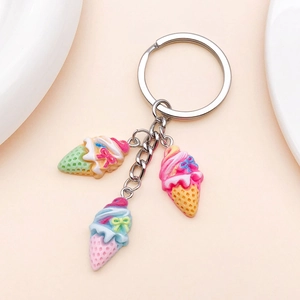 Detailed view of colorful resin ice cream cone charms with cute bow accents on a keychain