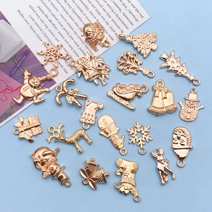Close-up of golden Christmas alloy pendants with deer and snowman for DIY jewelry making