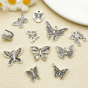 Detailed macro view of vintage silver alloy butterfly pendants for DIY jewelry making