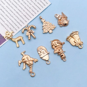 Detailed macro view of festive gold Christmas charms for DIY jewelry making accessories