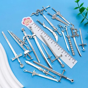 Macro view of vintage silver alloy sword charms in various styles with size ruler