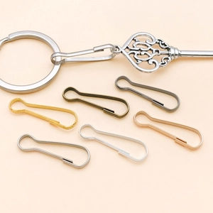 Set of multi-colored iron spring hooks and vintage key pendant for DIY jewelry making