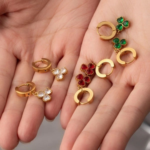 Detailed view of 18K gold plated clover earrings featuring red green and white heart stones