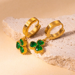 Close-up of gold titanium steel earrings with heart-shaped green zirconia clover pendant