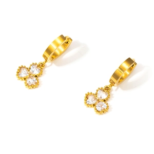 Close-up of 18K gold clover earrings with heart-shaped zircon and beaded edge detail