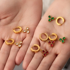 Detailed shot of titanium steel clover earrings with red green and white teardrop gems