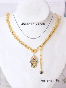 Detail of vintage gold Hamsa hand necklace with colorful evil eye charms and chain length specs