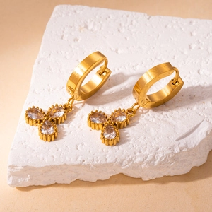 Detail of 18K gold plated stainless steel hoop earrings with clover shaped cubic zirconia