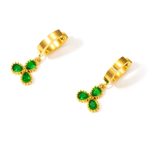 Close-up of gold clover earrings featuring green pear-cut gemstones and 18K gold plating