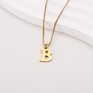 Detailed close-up of a golden capital letter B pendant necklace with a stylish box chain