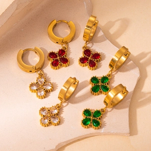 Detailed macro view of 18K gold plated clover earrings with red green and white gemstones