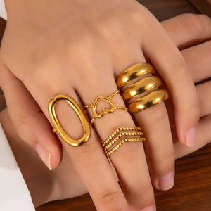 Set of four gold stainless steel rings with minimalist geometric and heart patterns