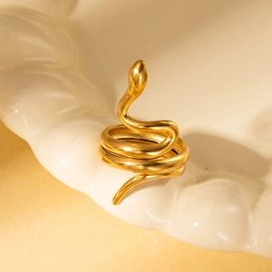 Close-up of golden multi-layered snake ring showing intricate textured scales and coiled design
