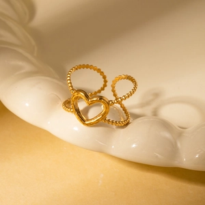 Detail of a gold-plated irregular double-layered beaded ring with a hollow heart center