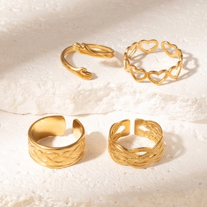 Set of four vintage gold adjustable titanium steel rings featuring unique textured patterns