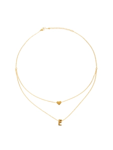 Detail of double-layer gold plated necklace featuring heart charm and letter E pendant