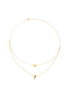 Detail of gold-plated double-layer necklace with heart and letter F pendant