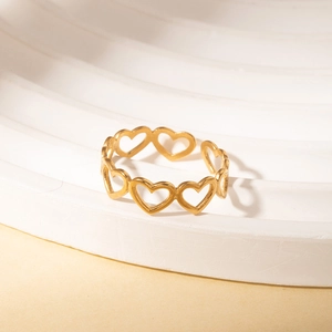 Detail of matte gold hollow heart ring featuring an adjustable open band design