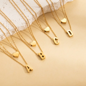 Double-layered gold titanium steel necklace featuring heart and letter pendants