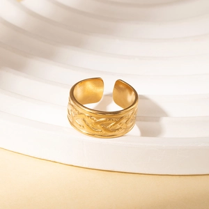 Detailed macro view of retro gold adjustable ring with braided texture and relief pattern