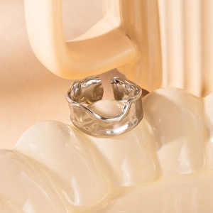 Detail of silver wavy adjustable open ring with liquid metal texture and ripple design