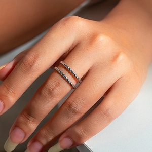 Close-up of double layer silver beaded ring on model hand with minimalist design