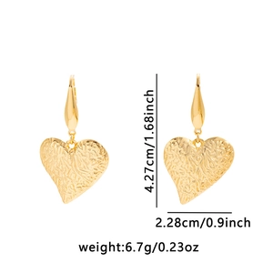 Detail view of golden textured heart earrings with size markers 4.27cm and 2.28cm