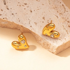 Detailed view of 18K gold plated heart earrings with sparkling cubic zirconia inlay