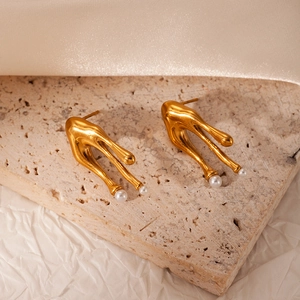 Gold bowknot stainless steel earrings with fluid lava design and white pearls